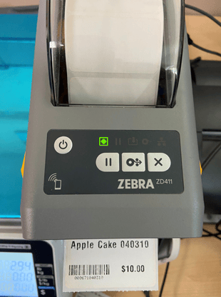 Image showing a Zebra Printer printing a shelf label for Apple Cake.