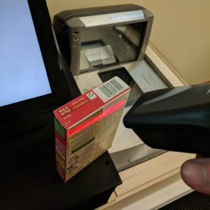 Image of someone scanning an item with a handheld scanner.